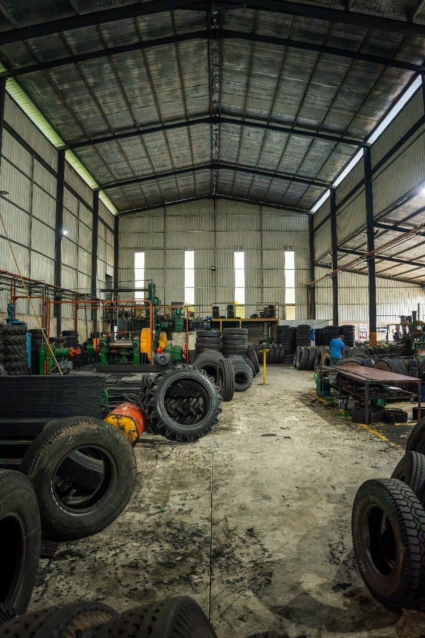 Inside Autoways Anuradhapura manufacturing facility: heavy rubber compounding, hot cure, and cold cure processing bays with Sri Lankan workforce.