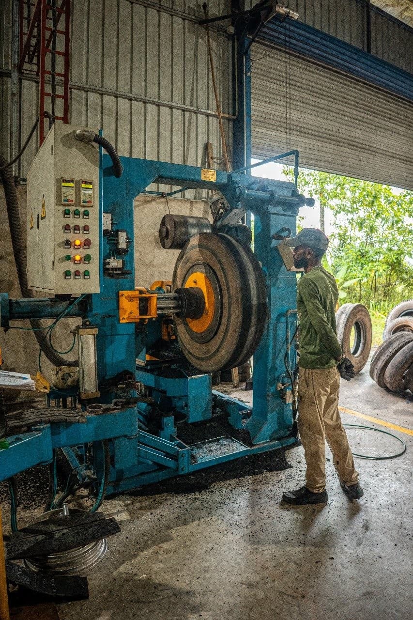 Autoways Sri Lankan technician operating the heavy commercial tyre rebuilding and buffing machine in Anuradhapura.